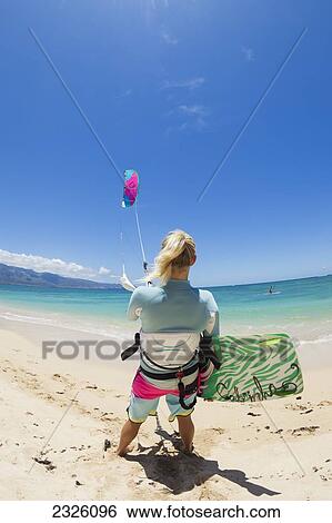 Hawaii, Maui, Prefessional Kiteboarder Susi Mai Preparing To Surf Off The North Shore. Editorial Use Only. View Large Photo Image Stock Photograph - Hawaii, Maui, Prefessional Kiteboarder Susi Mai Preparing To Surf Off The North Shore. Editorial Use Only.. Fotosearch