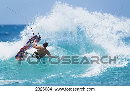 Picture - Hawaii, Maui, Professional Kiteboarder Niccolo Porcella Surfing A Large Wave. Editorial Use Only.. Fotosearch