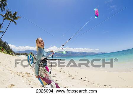 Picture - Hawaii, Maui, Professional Kiteboarder Susi Mai Preparing To Surf Off The North Shore. Editorial Use Only.. Fotosearch