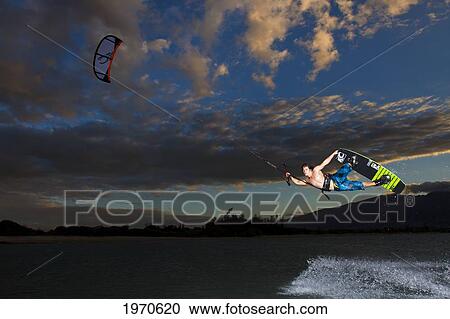 Stock Image - Hawaii, Maui, Professional Kiteboarder Jesse Richman Riding At Kitebeach At Night. For Editorial Use Only.. Fotosearch