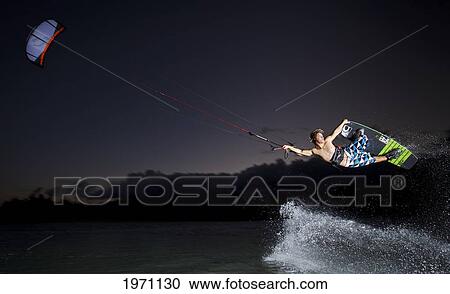 Stock Image - Hawaii, Maui, Professional Kiteboarder Jesse Richman Riding At Kitebeach At Night. For Editorial Use Only.. Fotosearch