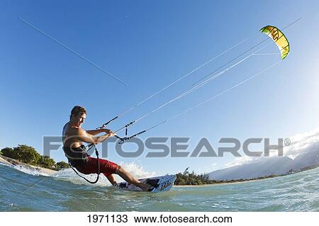 Stock Image - Hawaii, Maui, Professional Kiteboarder Patri Mclaughlin Riding At Kitebeach. For Editorial Use Only.. Fotosearch