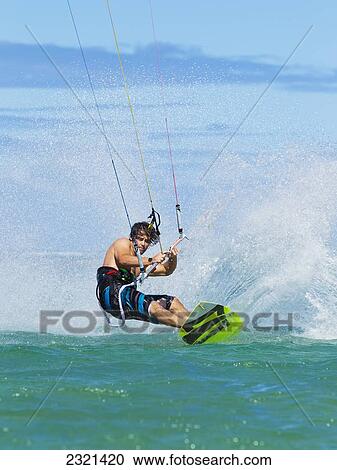 Stock Image - Hawaii, Maui, Professional Kiteboarder, Shawn Richman Riding In Ocean. Editorial Use Only.. Fotosearch
