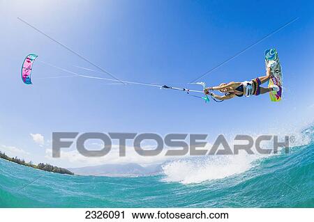 Stock Image - Hawaii, Maui, Professional Kiteboarder Susi Mai Catching Air Off The North Shore. Editorial Use Only.. Fotosearch