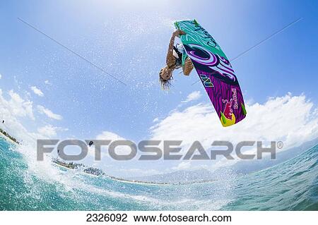 Stock Image - Hawaii, Maui, Professional Kiteboarder Susi Mai Catching Air Off The North Shore. Editorial Use Only.. Fotosearch
