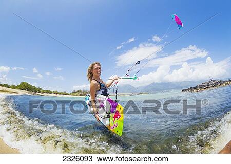 Stock Image - Hawaii, Maui, Professional Kiteboarder Susi Mai Preparing To Surf Off The North Shore. Editorial Use Only.. Fotosearch