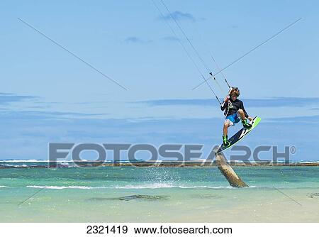 Hawaii, Maui, Professional Kiteboarder, Jesse Richman Riding Right Over A Tree Stump In Ocean. Editorial Use Only. View Large Photo Image Stock Photo - Hawaii, Maui, Professional Kiteboarder, Jesse Richman Riding Right Over A Tree Stump In Ocean. Editorial Use Only.. Fotosearch