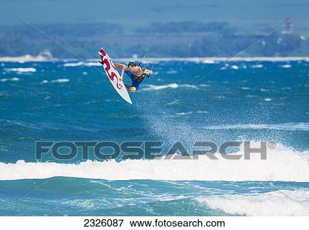 Stock Photo - Hawaii, Maui, Professional Kiteboarder Niccolo Porcella Catching Air Off The North Shore. Editorial Use Only.. Fotosearch