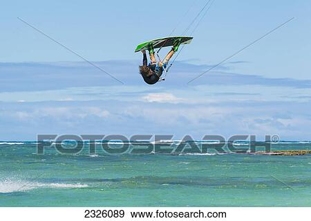 Stock Photo - Hawaii, Maui, Professional Kiteboarder Jesse Richman Catching Air Off The North Shore. Editorial Use Only.. Fotosearch
