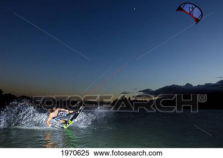 Stock Photography - Hawaii, Maui, Professional Kiteboarder Jesse Richman Riding At Kitebeach At Night. For Editorial Use Only.. Fotosearch