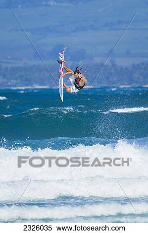 Stock Photography - Hawaii, Maui, Professional Kiteboarder, Nicolo Porcella Riding The Ocean Waves. Editorial Use Only.. Fotosearch