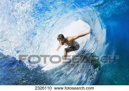 Stock Image - Hawaii, Maui, Professional Surfer Ola Eleogram Surfing The Barrel Of A Wave. Editorial Use Only.. Fotosearch