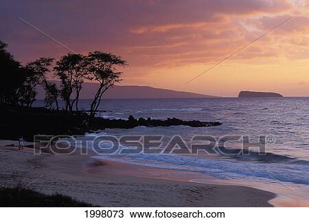 Stock Image - Hawaii, Maui, Soft Moody Sunset From Kihei With Molokini In Background. Fotosearch
