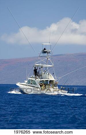 Stock Photography - Hawaii, Maui, Sportfishing Boat Cruising In Blue Ocean Water, Kahoolawe In Background.. Fotosearch