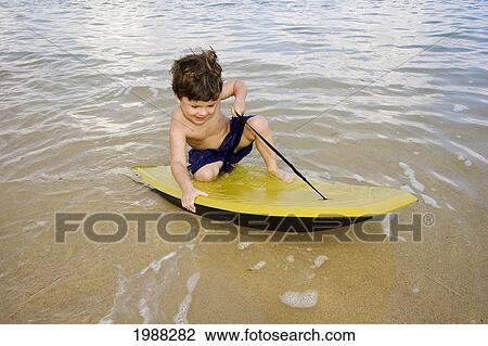 Hawaii, Maui, Spreckelsville, Baby Beach, Young Boy Playing In The Water On A Boogieboard View Large Photo Image Stock Image - Hawaii, Maui, Spreckelsville, Baby Beach, Young Boy Playing In The Water On A Boogieboard. Fotosearch