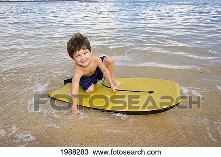 Hawaii, Maui, Spreckelsville, Baby Beach, Young Boy Playing In The Water On A Boogieboard View Large Photo Image Stock Image - Hawaii, Maui, Spreckelsville, Baby Beach, Young Boy Playing In The Water On A Boogieboard. Fotosearch