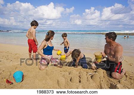 Hawaii, Maui, Spreckelsville, Baby Beach, Family On Vacation Building A Sandcastle. View Large Photo Image Stock Image - Hawaii, Maui, Spreckelsville, Baby Beach, Family On Vacation Building A Sandcastle.. Fotosearch