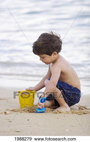 Hawaii, Maui, Spreckelsville, Baby Beach, Young Boy Playing In Sand. View Large Photo Image Stock Photo - Hawaii, Maui, Spreckelsville, Baby Beach, Young Boy Playing In Sand.. Fotosearch