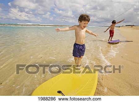 Hawaii, Maui, Spreckelsville, Baby Beach, Young Boys Playing In The Water On Boogieboards View Large Photo Image Stock Photograph - Hawaii, Maui, Spreckelsville, Baby Beach, Young Boys Playing In The Water On Boogieboards. Fotosearch