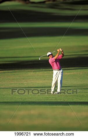 Stock Image - Hawaii, Maui, Spreckelsville Country Club, Full Length Front View Of Jim Bendon Fairway Shot Shadows. Fotosearch