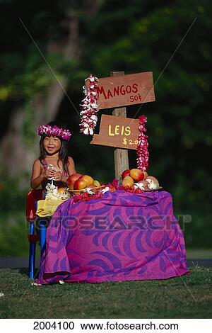 Stock Image - Hawaii, Maui, Spreckelsville, Full Length View Of Girl At Mango And Lei Stand, String Plumerias Roadside. Fotosearch