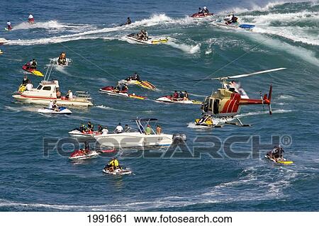Hawaii, Maui, Tow-In Surfers, Helicopter, Escort Boats And Jetski's At Peahi Aka Jaws. View Large Photo Image Stock Image - Hawaii, Maui, Tow-In Surfers, Helicopter, Escort Boats And Jetski's At Peahi Aka Jaws.. Fotosearch