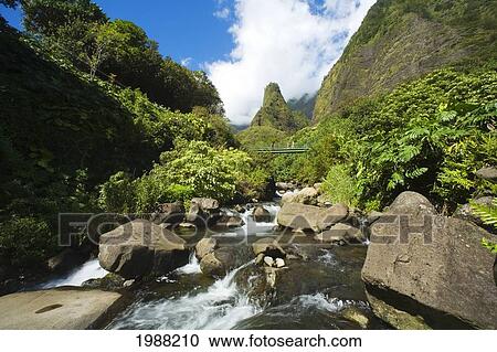 Stock Image - Hawaii, Maui, View Of Iao Needle With Stream, Blue Sky, Clouds. Fotosearch