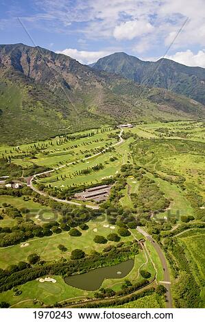 Stock Image - Hawaii, Maui, Waikapu, Aerial Of King Kamehameha Golf Course And West Maui Mountains. Fotosearch