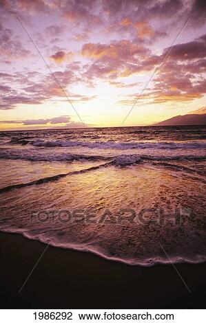 Stock Image - Hawaii, Maui, Wailea Beach At Sunset, Pink Clouds And Reflections On Water, Lanai In Distance.. Fotosearch
