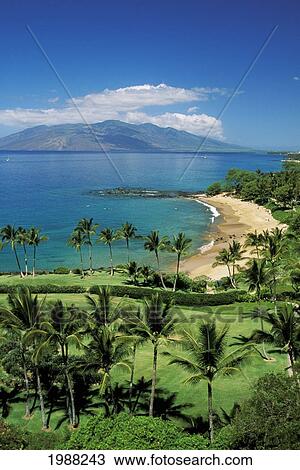Stock Image - Hawaii, Maui, Wailea Coastline, Ulua Beach, Golf Course In Foreground, Island In Distance.. Fotosearch