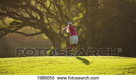 Stock Photography - Hawaii, Maui, Wailea Gold Golf Course, Female Golfer Swinging Golf Club.. Fotosearch