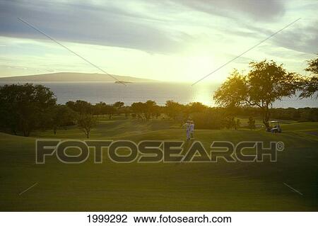 Hawaii, Maui, Wailea, Golf Couple At Sunset With Kahoolawe And Molokini Background View Large Photo Image Stock Image - Hawaii, Maui, Wailea, Golf Couple At Sunset With Kahoolawe And Molokini Background. Fotosearch