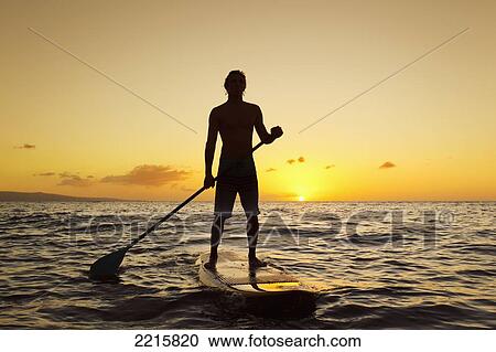 Stock Image - Hawaii, Maui, Wailea, Stand Up Paddling at Sunset.. Fotosearch