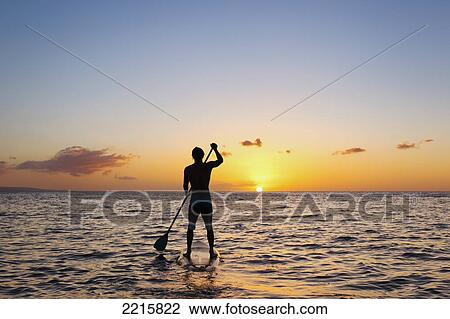 Stock Image - Hawaii, Maui, Wailea, Stand Up Paddling at Sunset.. Fotosearch