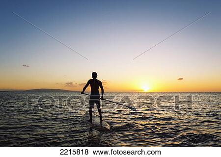 Hawaii, Maui, Wailea, Stand Up Paddling at Sunset. View Large Photo Image Stock Photo - Hawaii, Maui, Wailea, Stand Up Paddling at Sunset.. Fotosearch