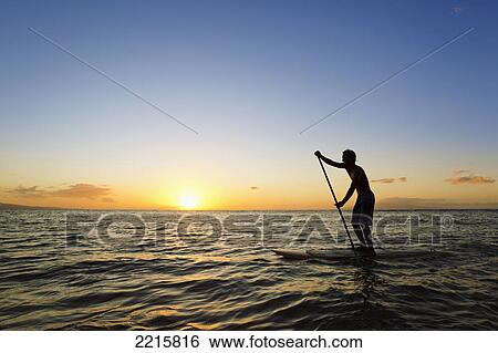 Stock Photograph - Hawaii, Maui, Wailea, Stand Up Paddling at Sunset.. Fotosearch