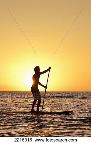 Stock Photograph - Hawaii, Maui, Wailea, Stand Up Paddling at Sunset.. Fotosearch