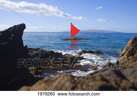 Stock Image - Hawaii, Maui, Wailea, Traditional Hawaiian Sailing Canoe Off Coastline.. Fotosearch