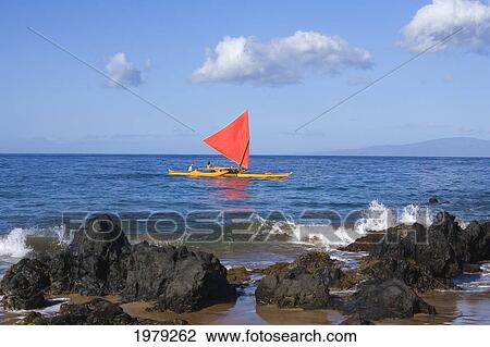 Stock Image - Hawaii, Maui, Wailea, Traditional Hawaiian Sailing Canoe Off Coastline.. Fotosearch