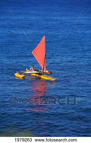 Stock Image - Hawaii, Maui, Wailea, Traditional Hawaiian Sailing Canoe Off Coastline.. Fotosearch