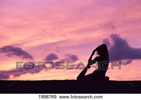Hawaii, Maui, Wailea, Woman Doing Yoga On Beach At Sunset With Pink Skies, B1205 View Large Photo Image Stock Photo - Hawaii, Maui, Wailea, Woman Doing Yoga On Beach At Sunset With Pink Skies, B1205. Fotosearch