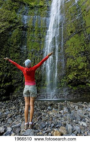 Hawaii, Maui, Waimoku Falls, Female Hiker At Base Of Waterfall. View Large Photo Image Stock Image - Hawaii, Maui, Waimoku Falls, Female Hiker At Base Of Waterfall.. Fotosearch