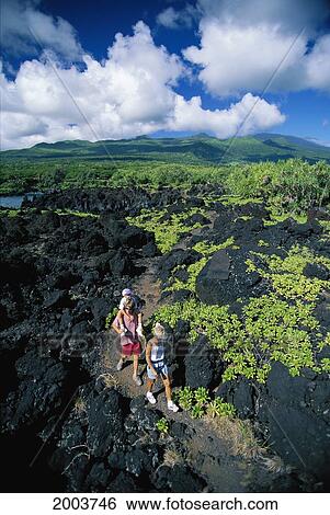 Stock Photograph - Hawaii, Maui, Wainapanapa State Park, Family Hike Along Kings Trail, Man Piggyback Boy. Fotosearch