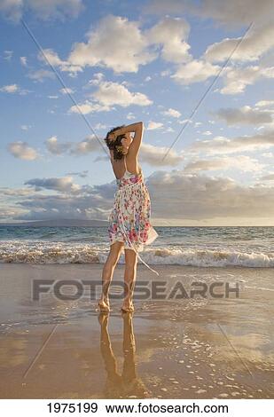 Stock Photo - Hawaii, Maui, Woman Standing On The Shore Of Remote Tropical Location.. Fotosearch
