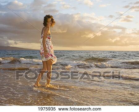Stock Photography - Hawaii, Maui, Woman Standing On The Shore Of Remote Tropical Location.. Fotosearch