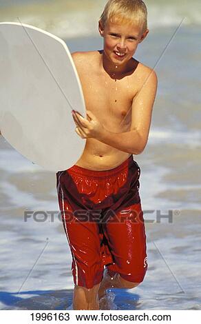 Hawaii, Maui, Young Caucasian Boy Launching Skimboard At Baldwin Beach View Large Photo Image Stock Image - Hawaii, Maui, Young Caucasian Boy Launching Skimboard At Baldwin Beach. Fotosearch