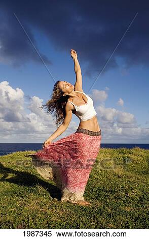 Hawaii, Maui, Young Woman Doing Yoga On Grassy Hill Next To The Ocean. View Large Photo Image Stock Photography - Hawaii, Maui, Young Woman Doing Yoga On Grassy Hill Next To The Ocean.. Fotosearch