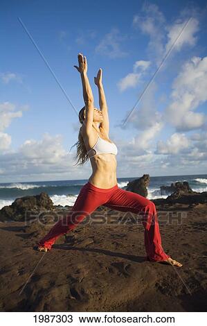 Stock Image - Hawaii, Maui, Young Woman Doing Yoga Next To The Ocean.. Fotosearch