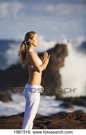 Stock Photograph - Hawaii, Maui, Young Woman Doing Yoga Next To The Ocean.. Fotosearch