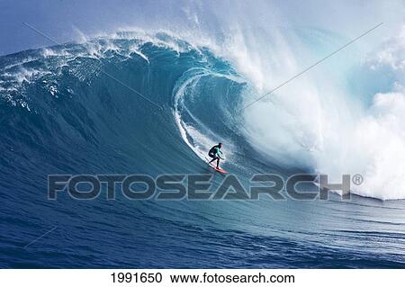 Stock Image - Hawaii, Maui, Yuri Farrant Surfs Huge Wave At Jaws, Aka Peahi.. Fotosearch